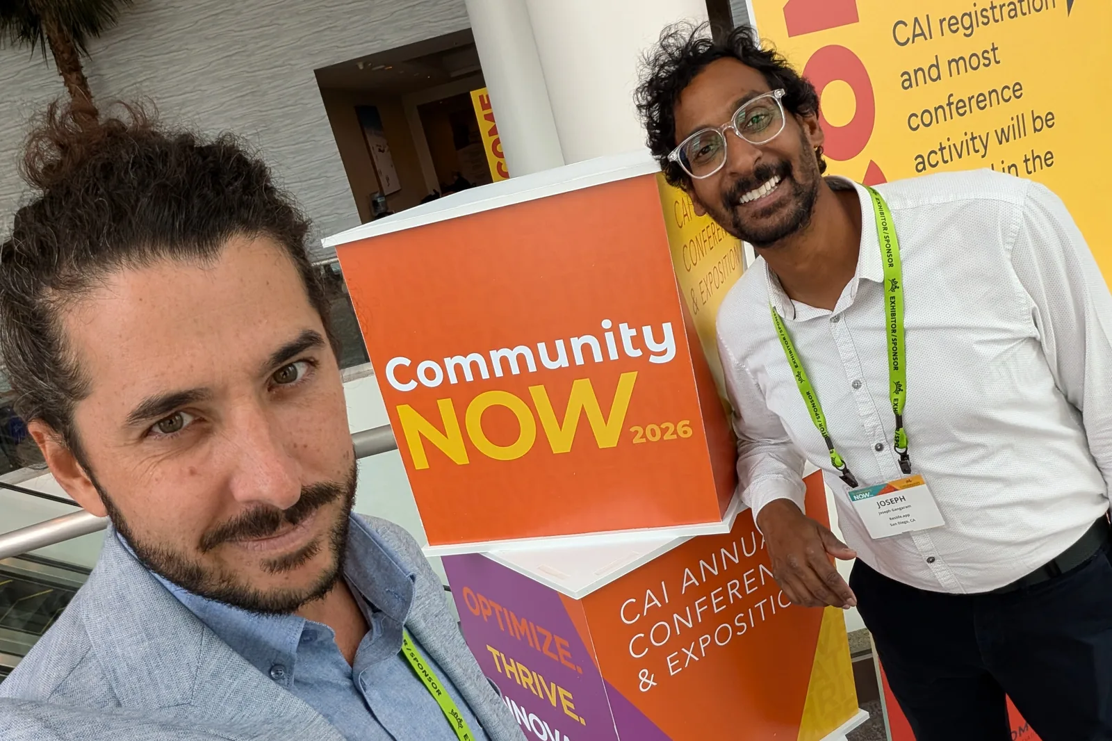 Brian Haghighi and Joseph Gangaram beside the Community NOW 2026 signage at the CAI Annual Conference and Exposition, Fort Lauderdale
